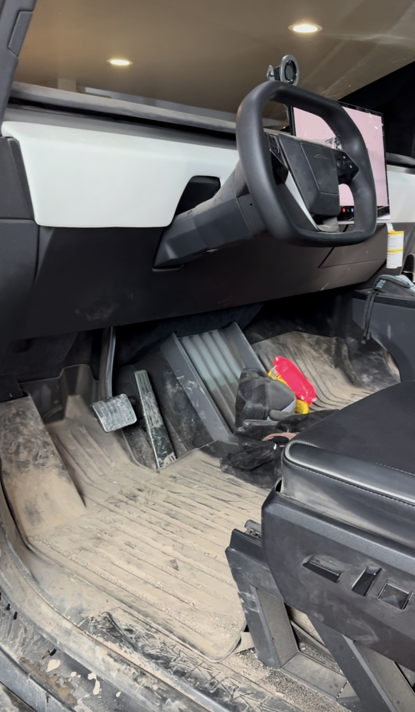 Tesla Cybertruck cab floor covered in dust and debris before a PRO DTLR interior reset