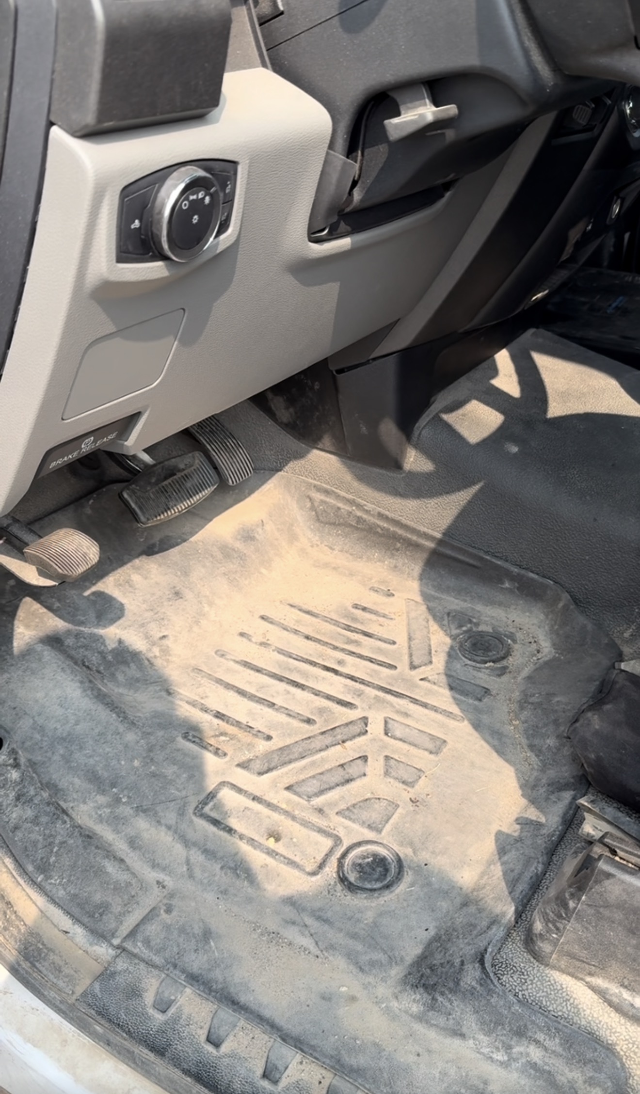 Dusty Ford truck driver-side floor mat before a mobile interior detail