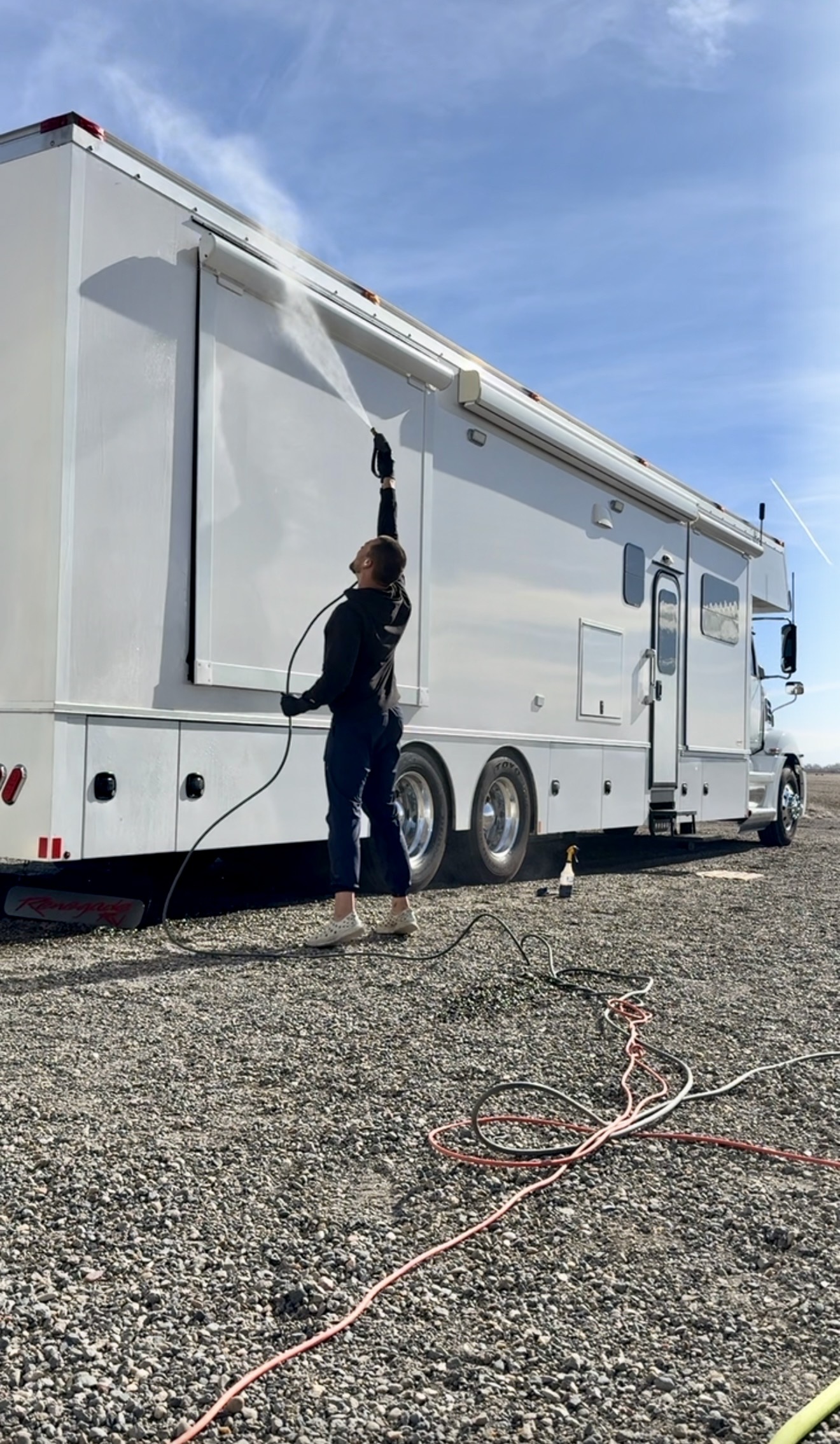 PRO DTLR detailer pressure washing the roof and awning of a large RV in Southeast Idaho