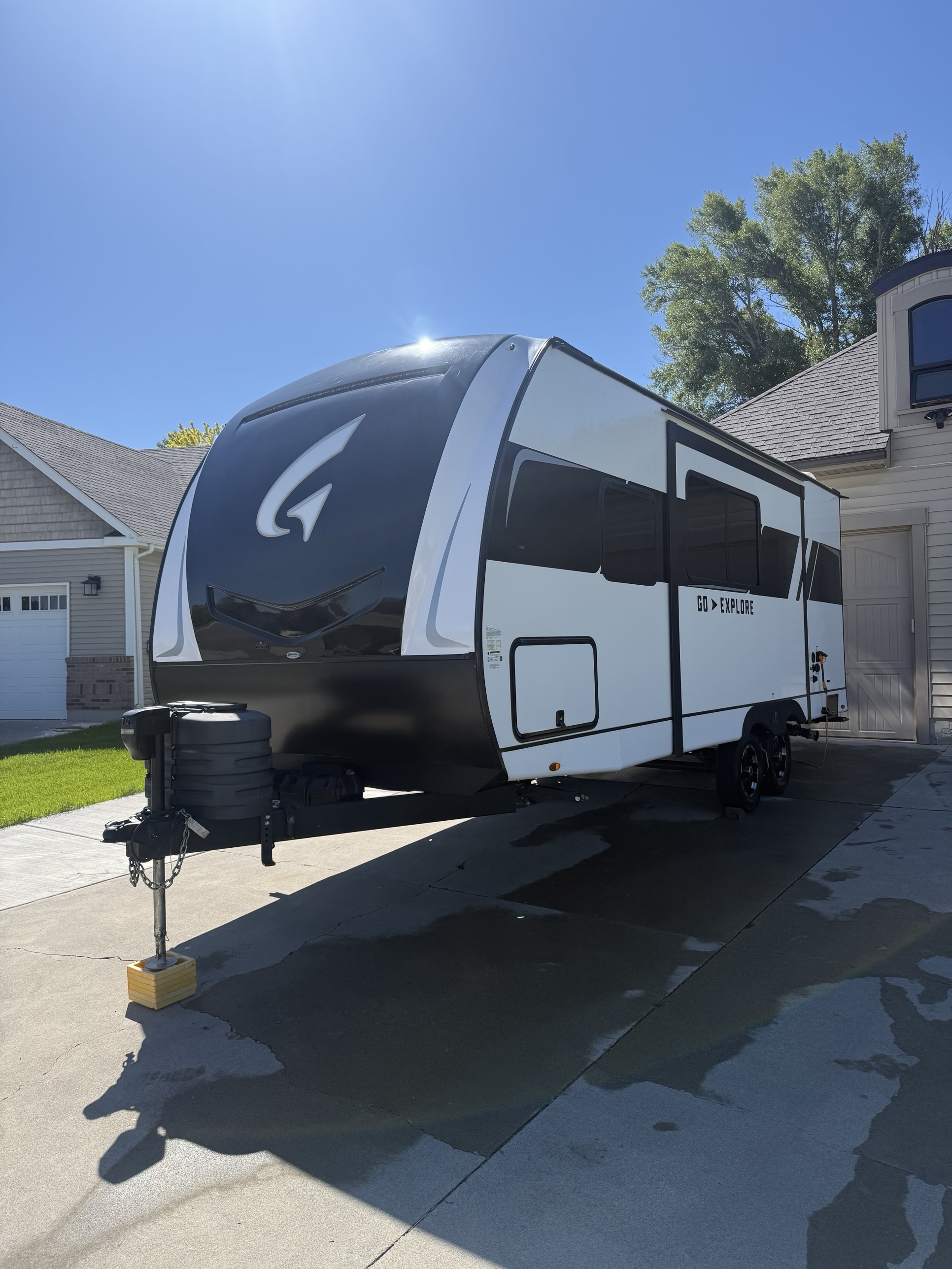 Travel trailer freshly washed and detailed in a Rexburg driveway